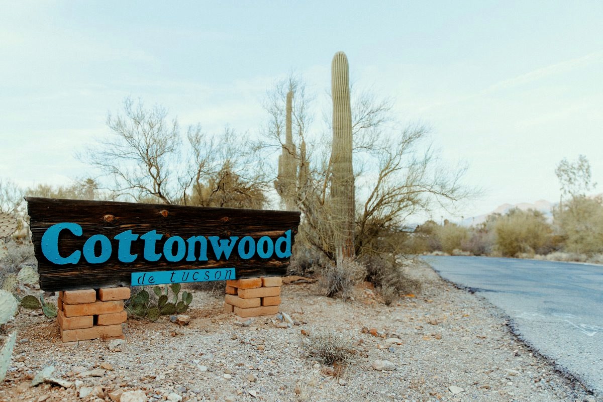 Cottonwood Tucson entrance sign beside the desert driveway