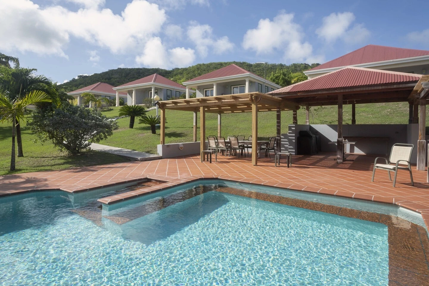 Pool, terrace and residential buildings at Crossroads Centre Antigua