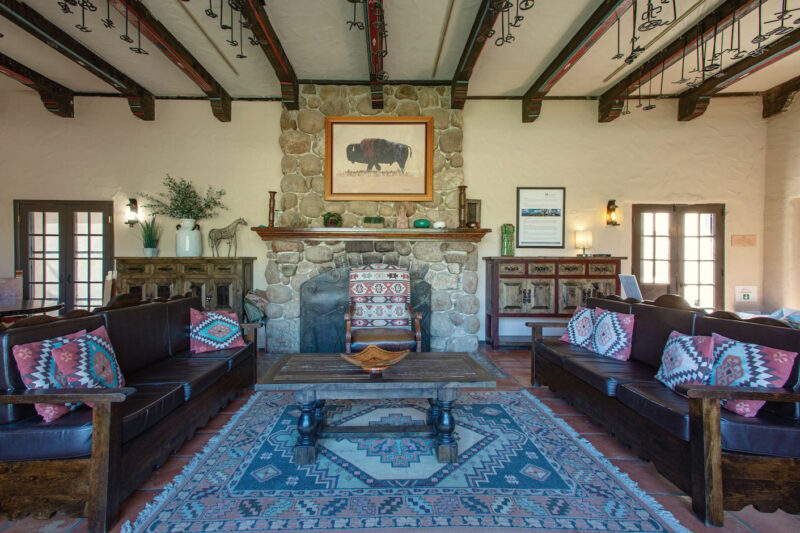 Southwestern-style lounge with stone fireplace at Sabino Recovery in Tucson