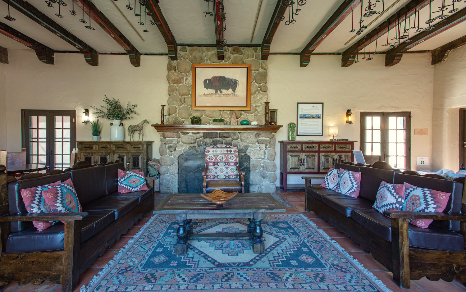 Southwestern-style lounge with stone fireplace at Sabino Recovery in Tucson