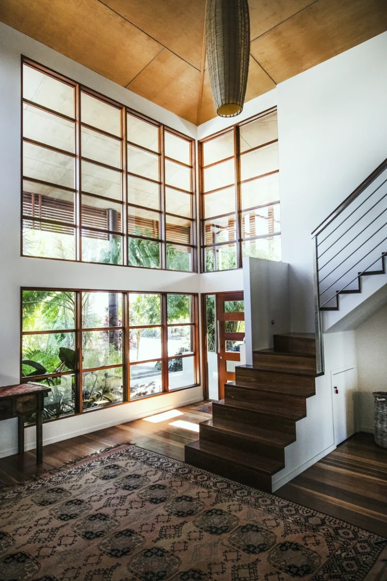 Window-lined staircase inside a private residence offered by The Sanctuary Byron Bay