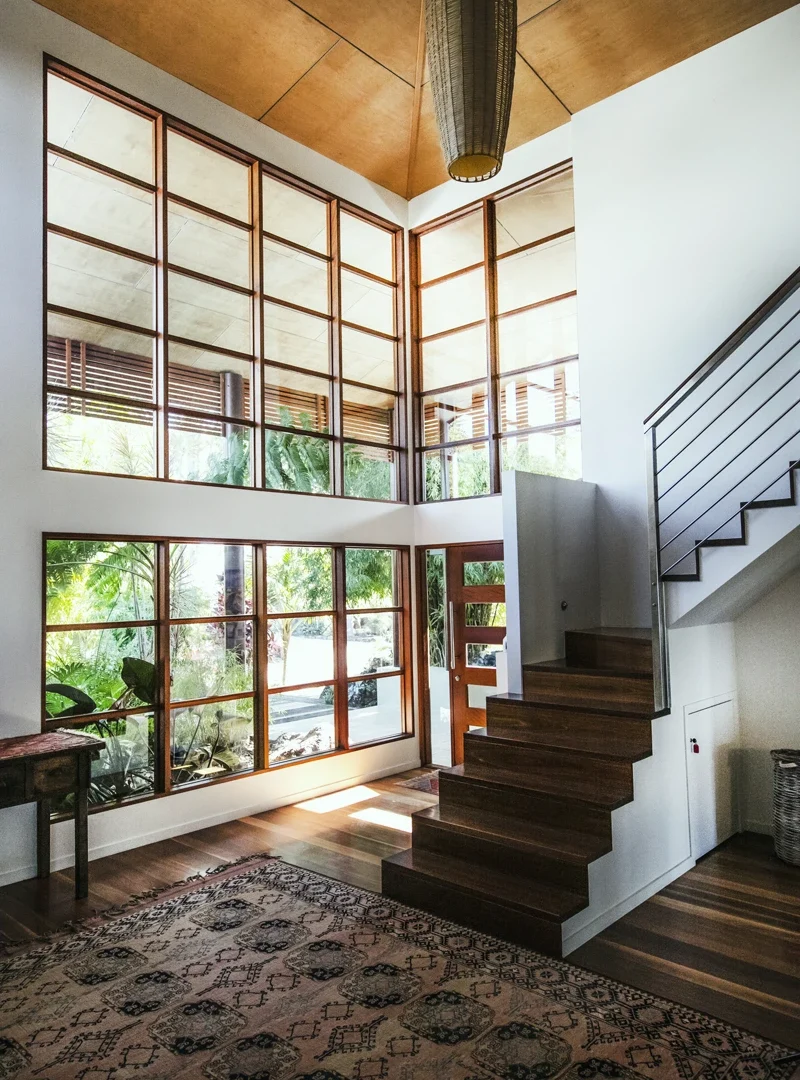 Window-lined staircase inside a private residence offered by The Sanctuary Byron Bay