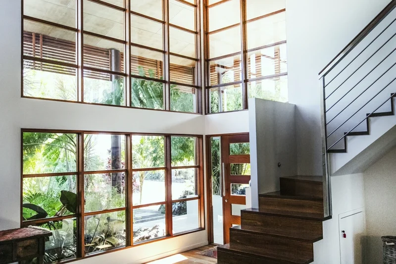 Window-lined staircase inside a private residence offered by The Sanctuary Byron Bay