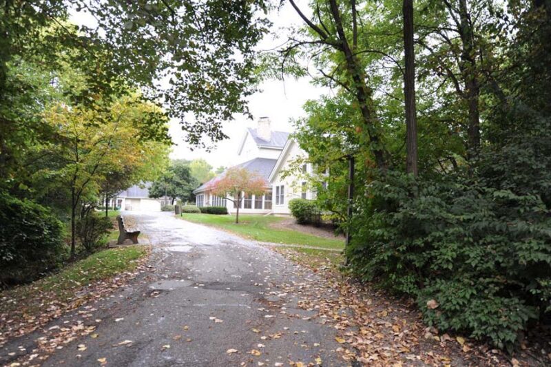 Wooded path and building at the former Timberline Knolls campus in Lemont, Illinois