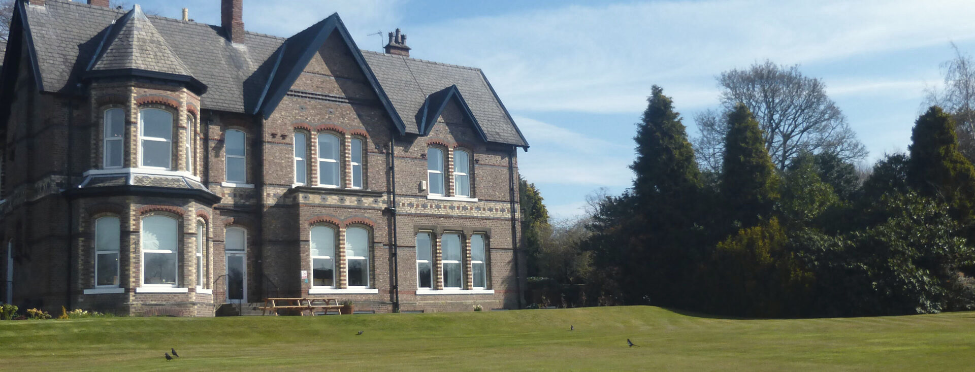 Priory Hospital Altrincham's main building and landscaped grounds in Hale, Cheshire