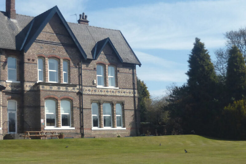 Priory Hospital Altrincham's main building and landscaped grounds in Hale, Cheshire