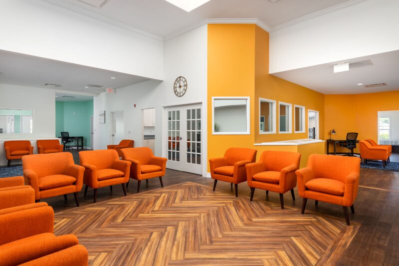 Orange-seated common area at the Discovery Mood and Anxiety Program residential center in Dade City, Florida