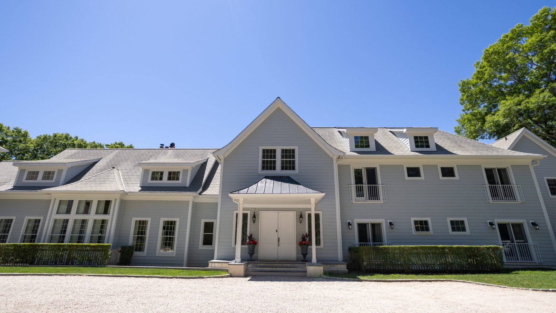 The Dunes East Hampton residence with landscaped hedges and a circular driveway