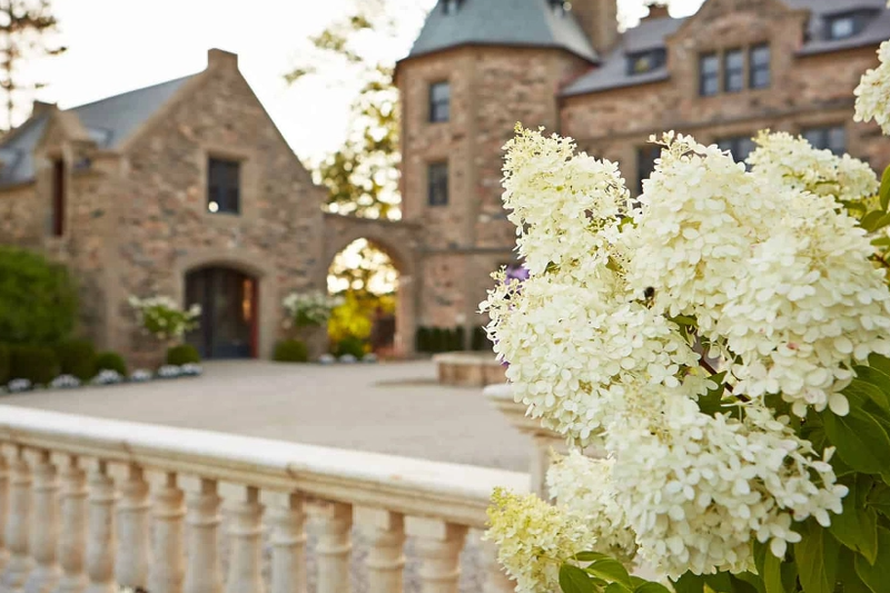 Stone buildings and flowering shrubs at the CMC:Berkshires estate