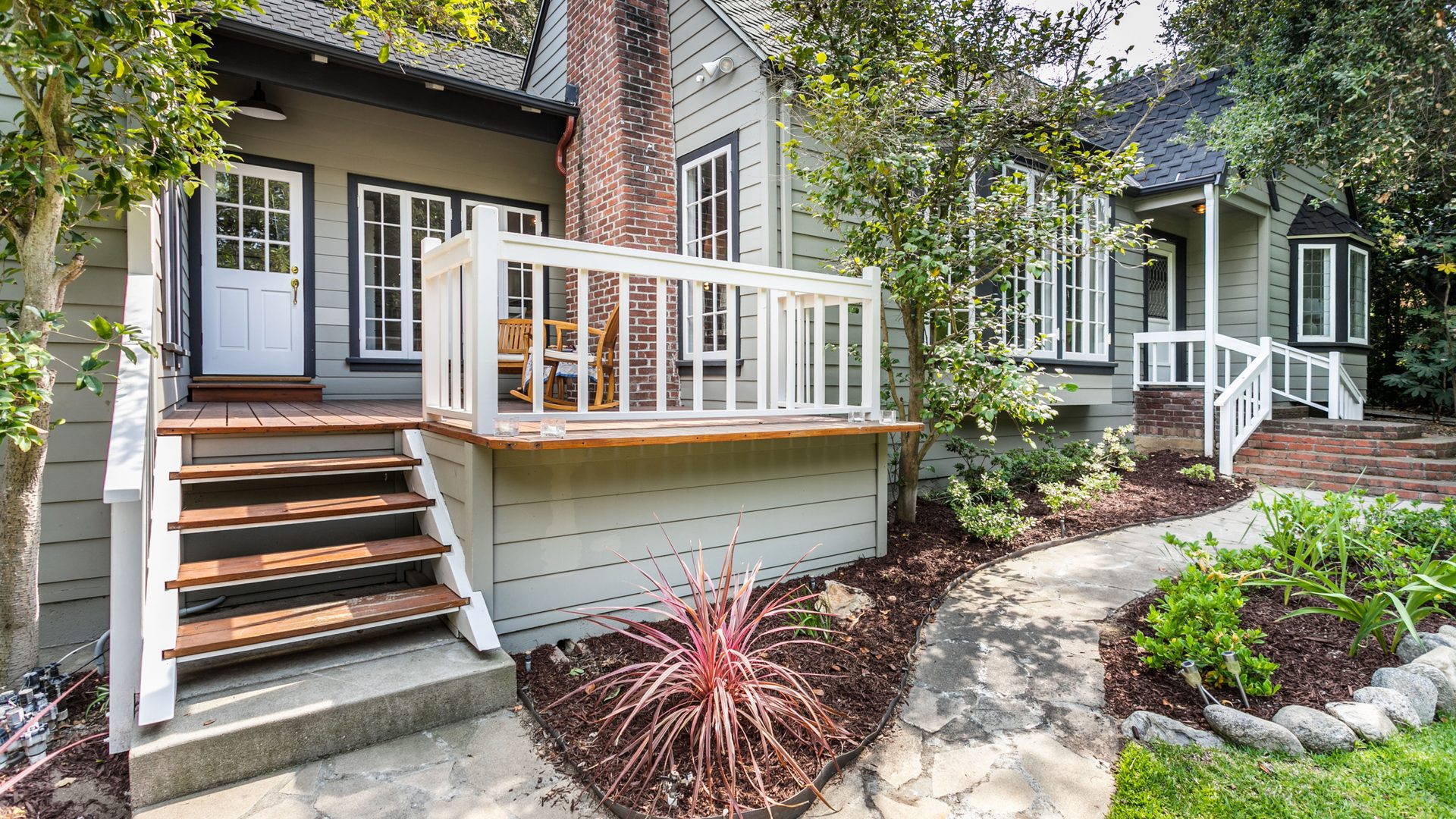 Annandale Behavioral Health residence with a wooden porch and landscaped garden path