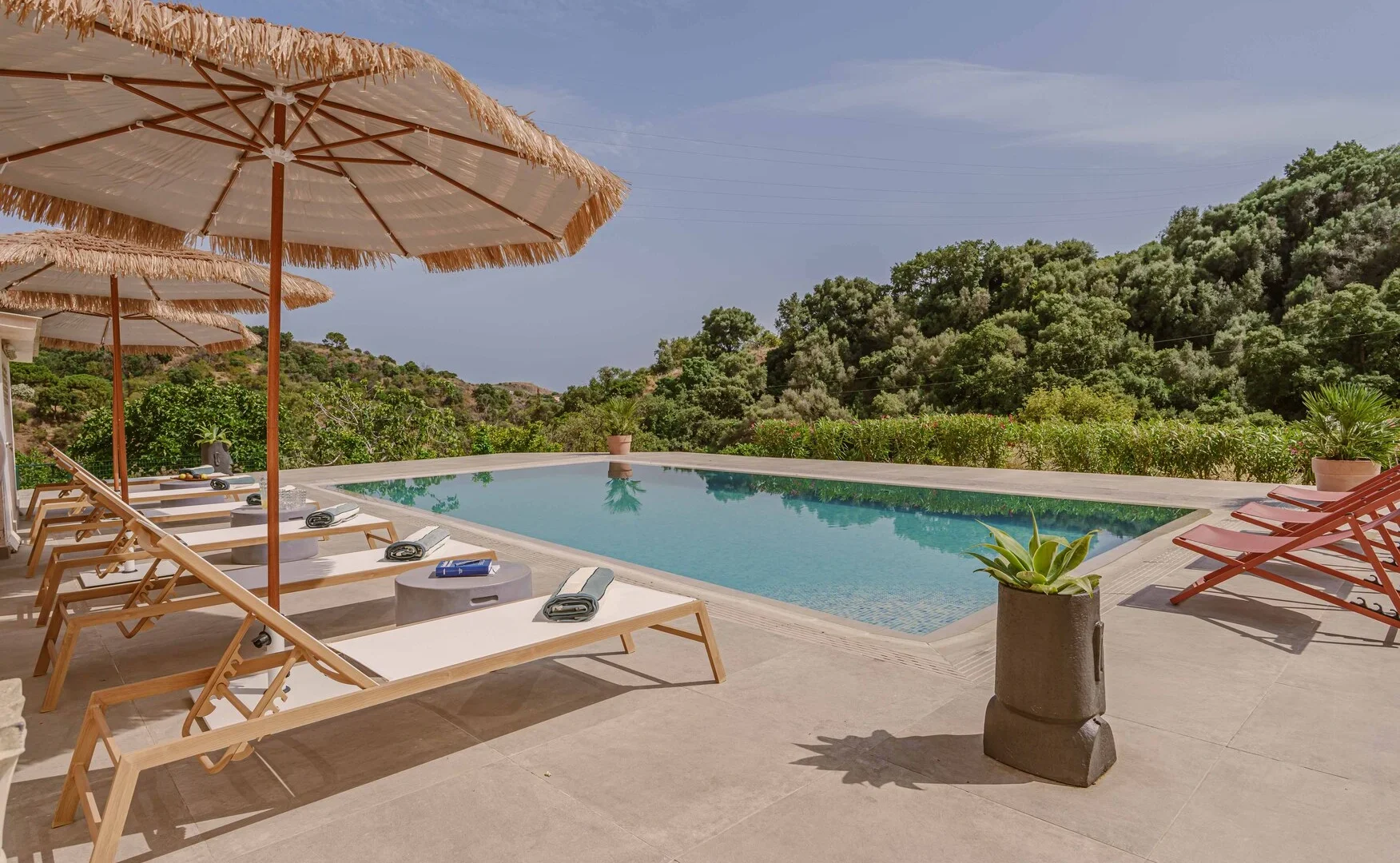 Outdoor swimming pool and sun loungers at InnerLife Recovery