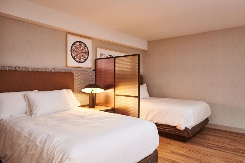 Guest room with two beds and a privacy screen at Homewood Ravensview