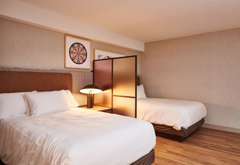 Guest room with two beds and a privacy screen at Homewood Ravensview