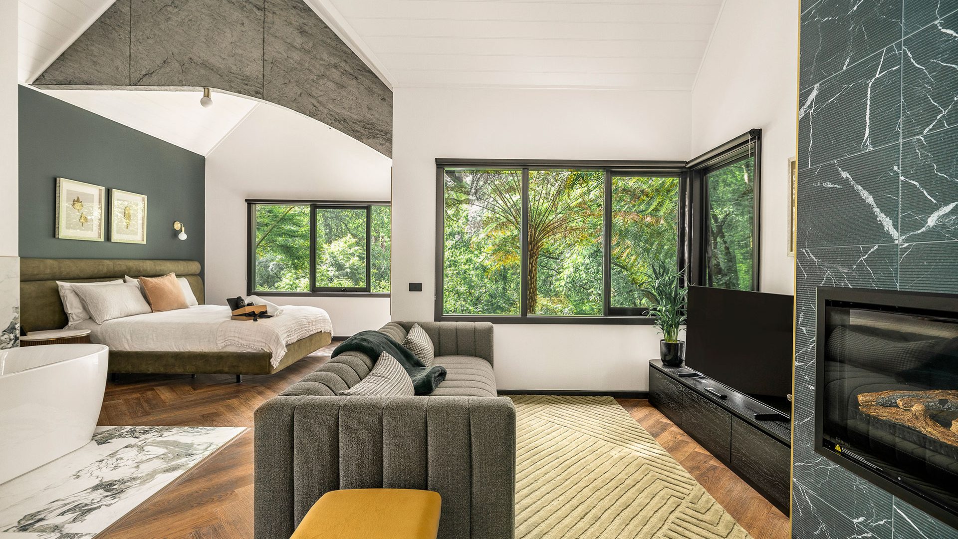 Suite with a sitting area and forest views at HARP Private Rehab